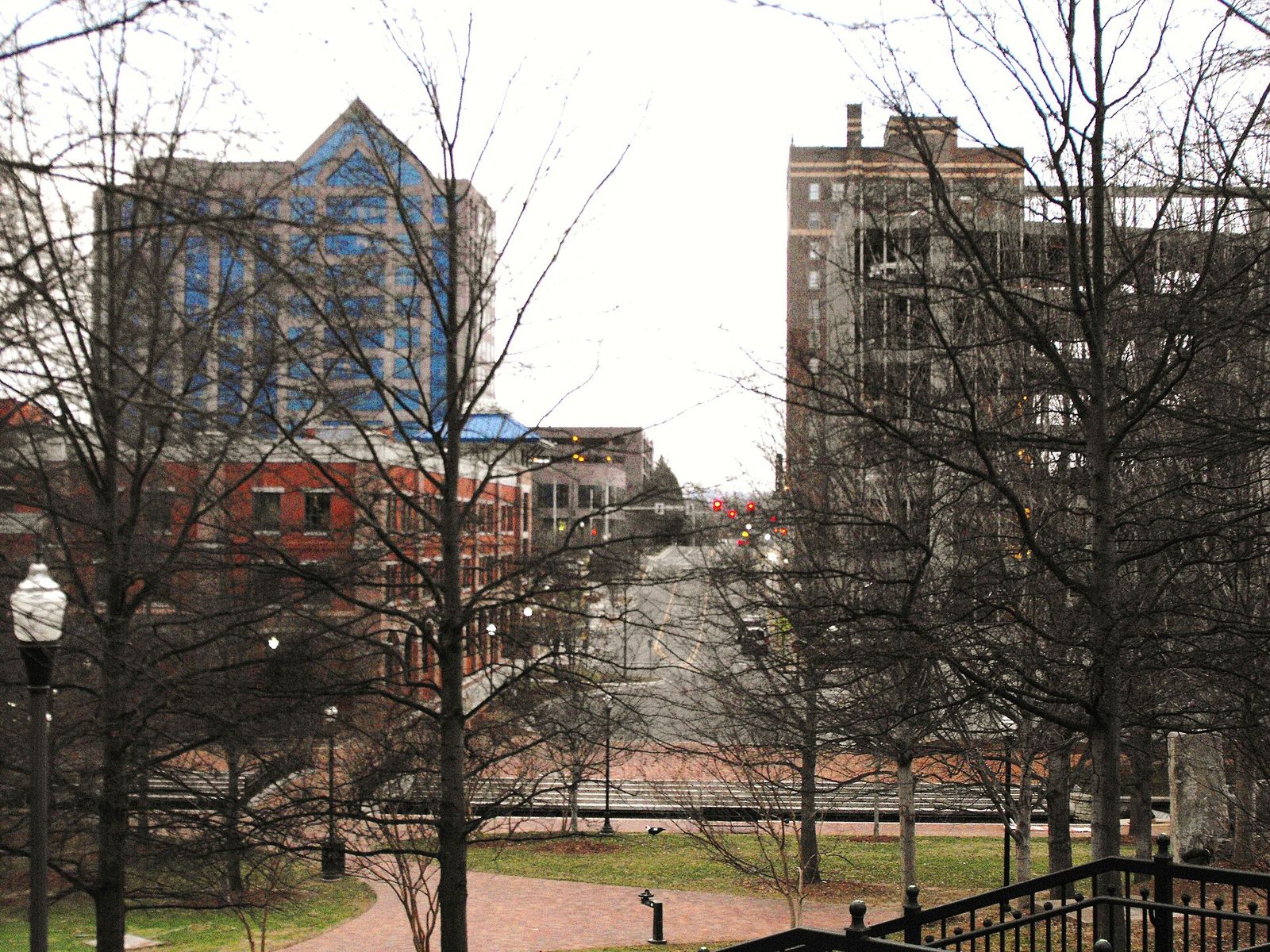 Downtown Huntsville buildings behind a row of bare winter trees