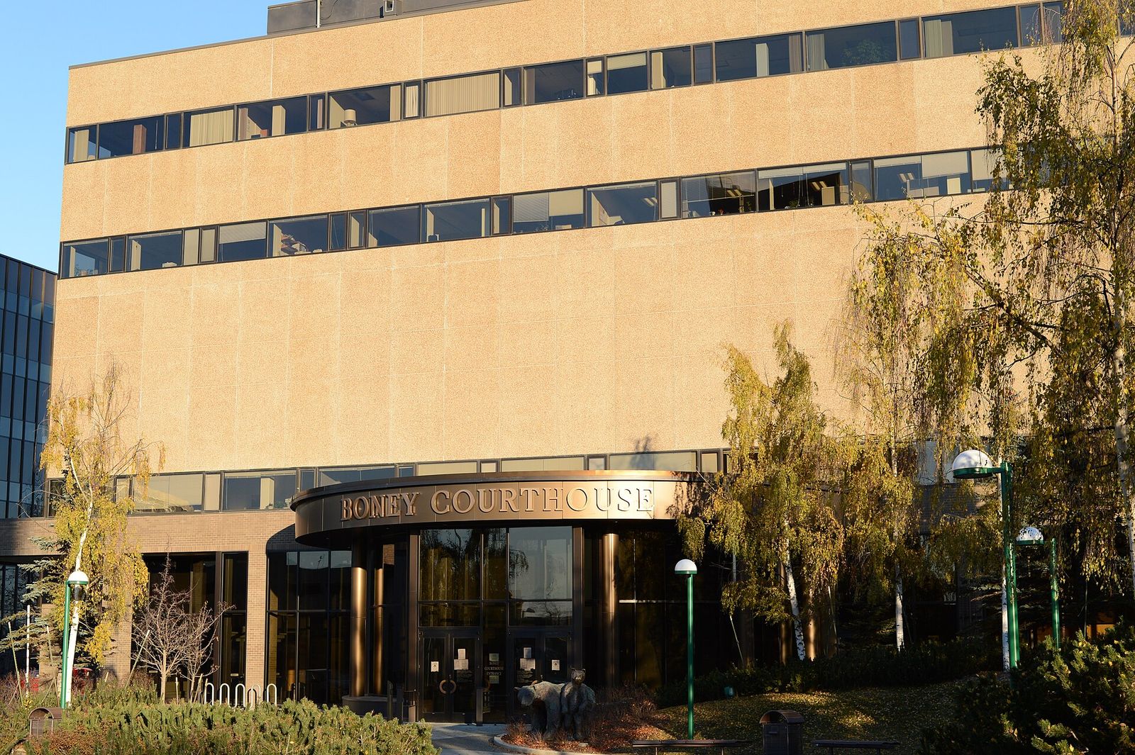 The Boney Courthouse in downtown Anchorage, with its name above the entrance and autumn trees in front