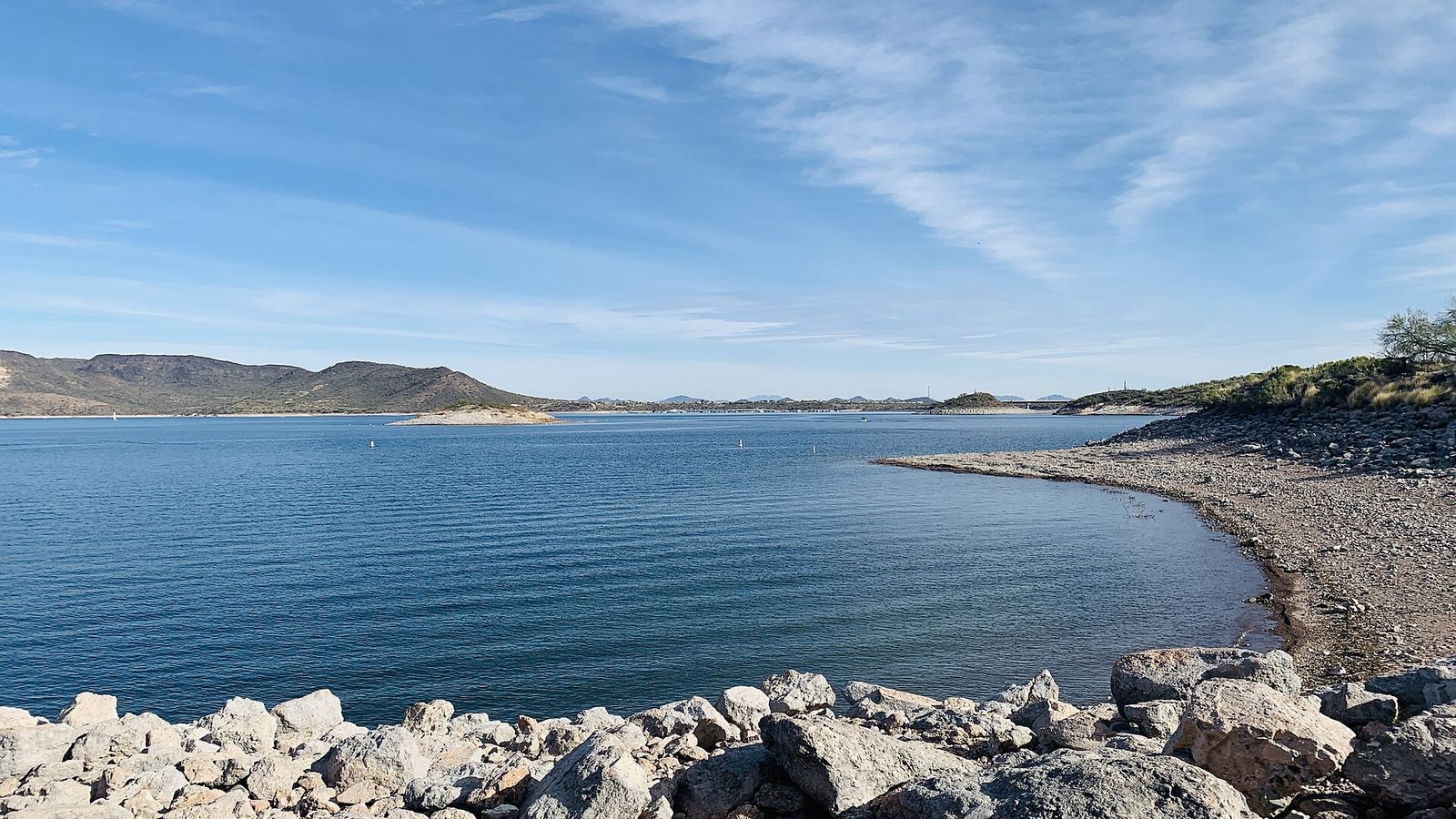 Lake Pleasant in northern Peoria, its blue water edged by a rocky shoreline and desert hills
