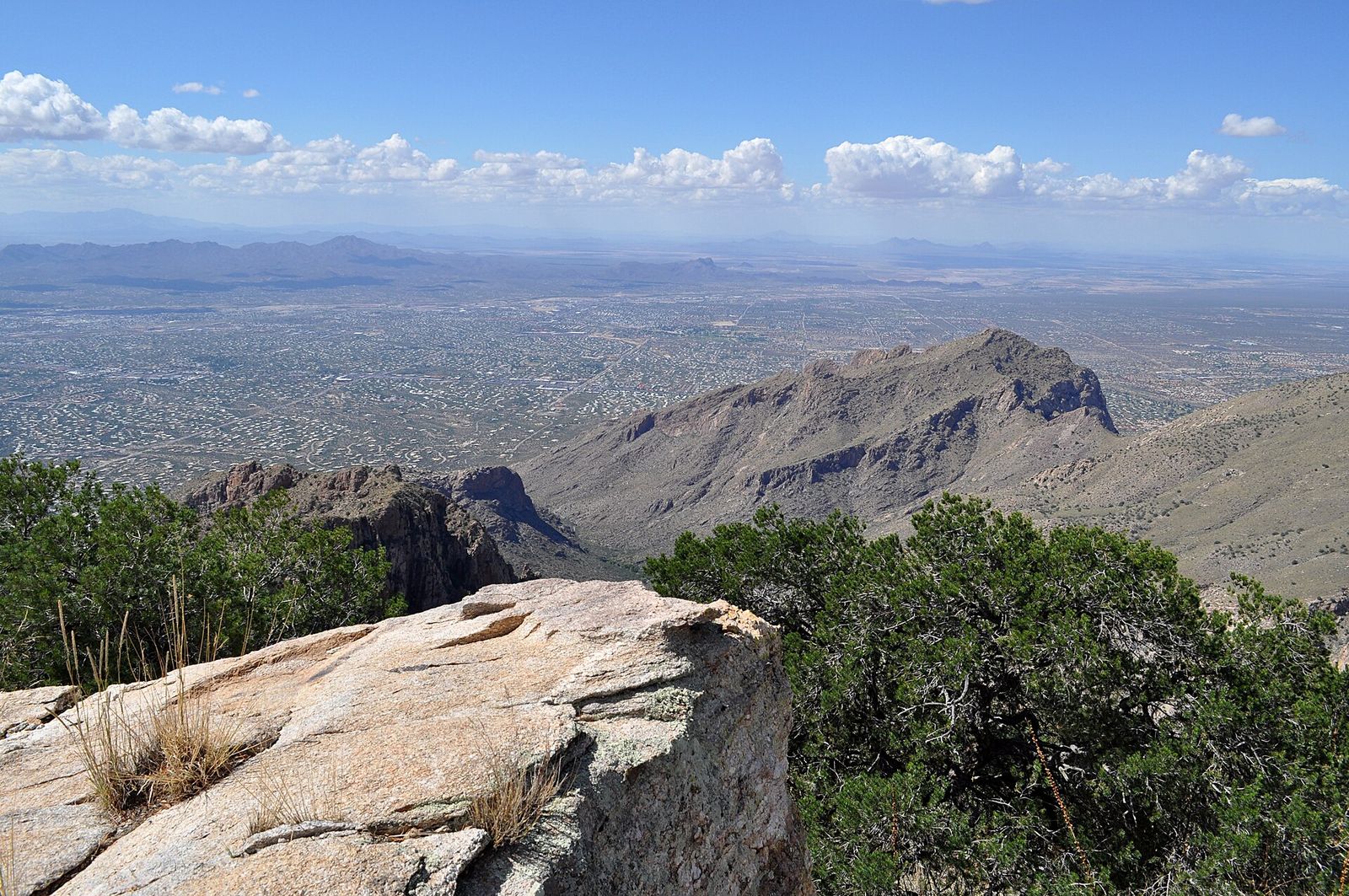 The northwest Tucson metro area spread across the valley, seen from a rocky summit in the Santa Catalina Mountains