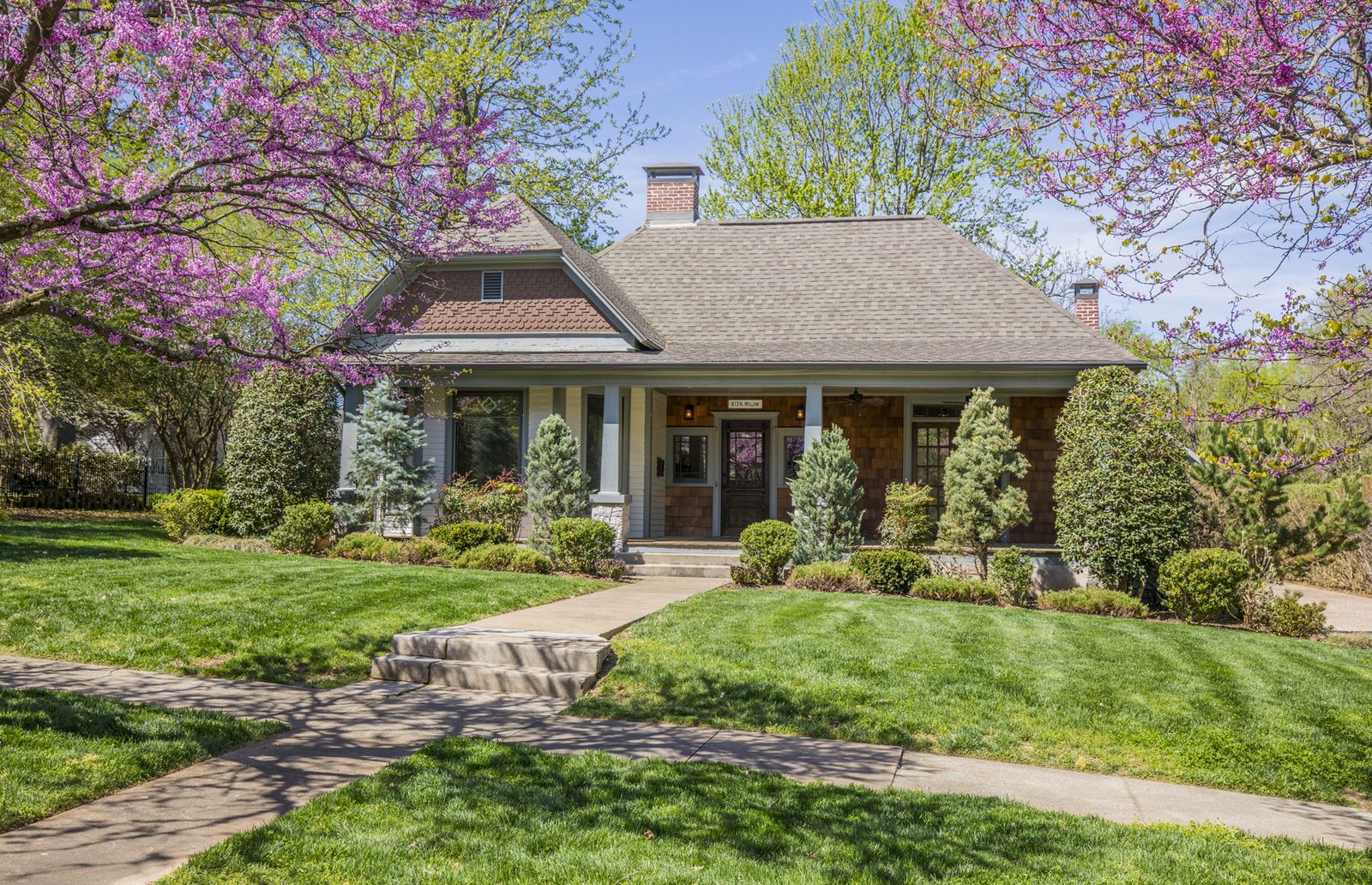 A historic house with a blossoming tree on Willow Avenue in Fayetteville, Arkansas