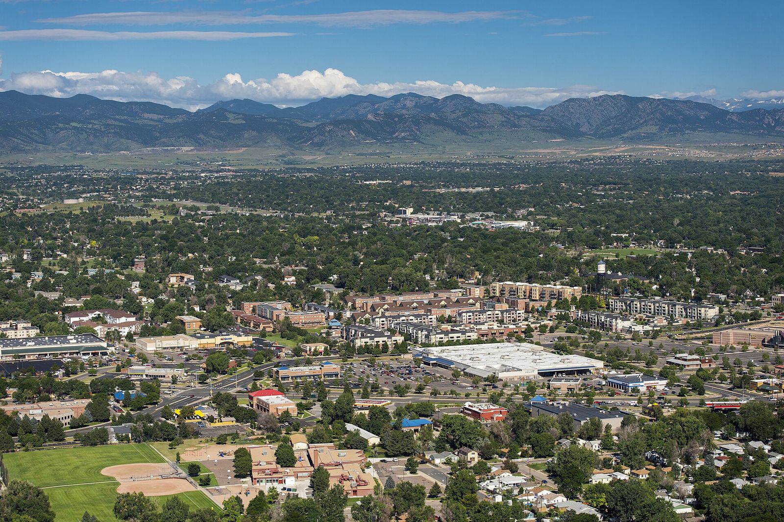 An aerial view of Arvada, Colorado, with neighborhoods, trees and open space