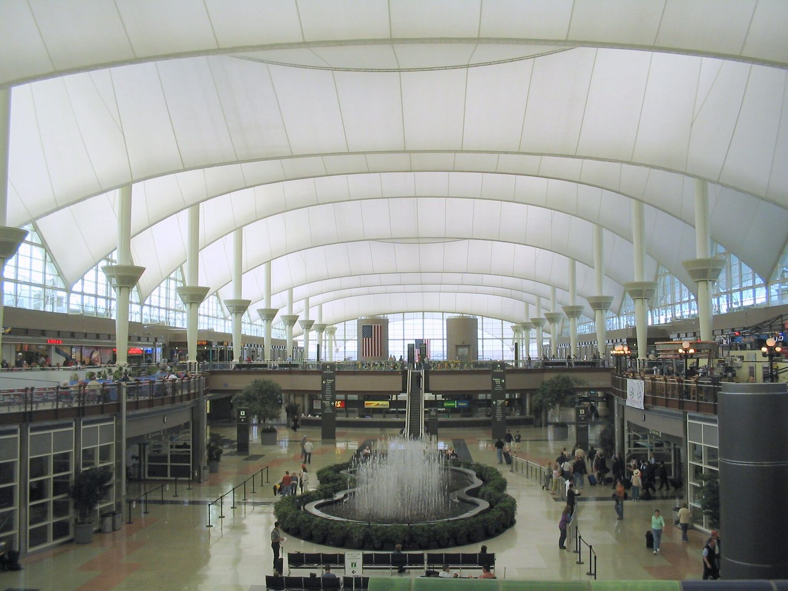 The white tented roof of the Great Hall in the Jeppesen Terminal at Denver International Airport, with a fountain on the floor below
