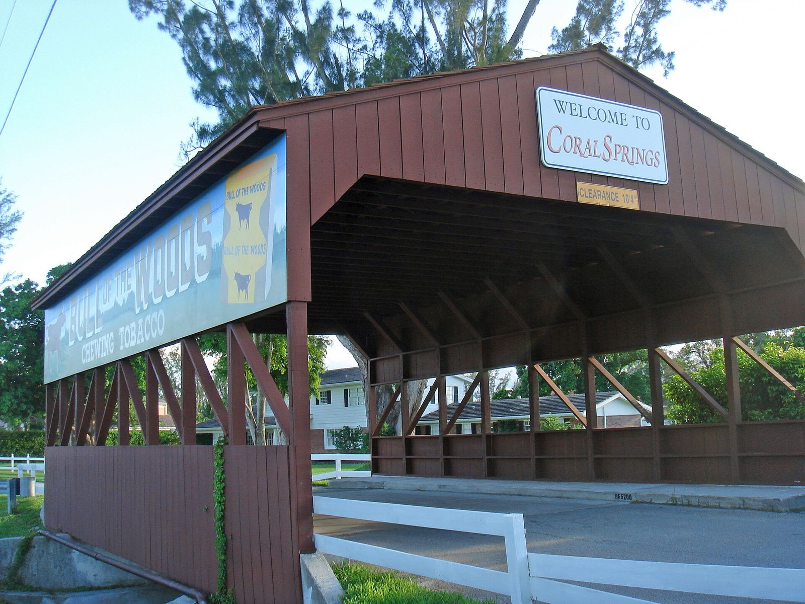The red Coral Springs Covered Bridge with its welcome sign