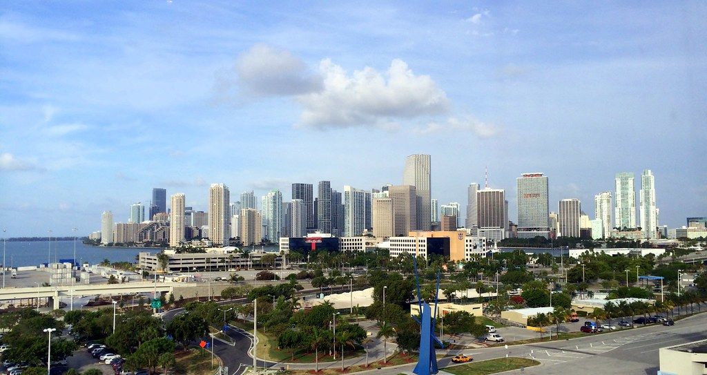 Cruise ships docked at PortMiami with the Miami skyline behind