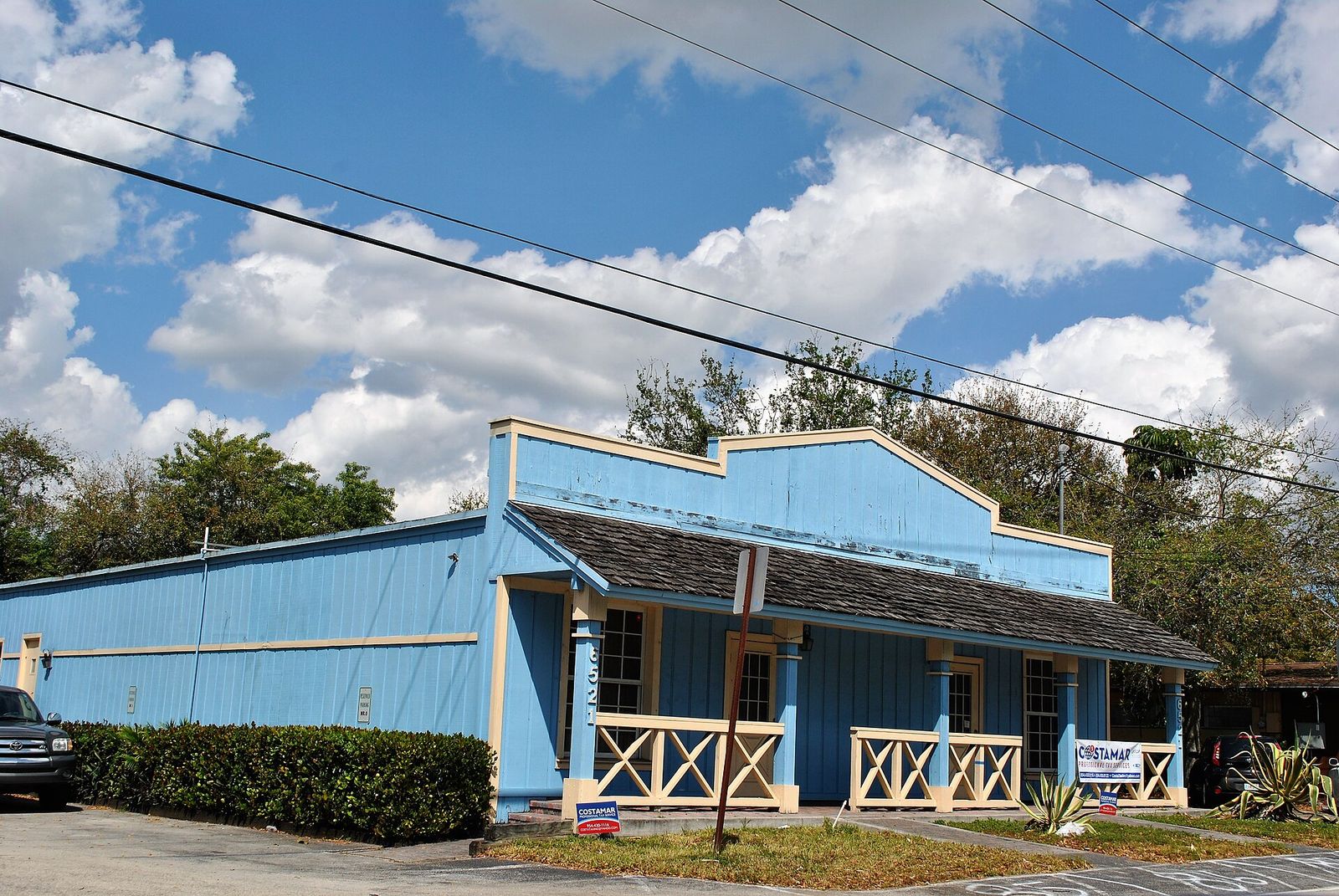 A blue Western-style storefront with a covered porch in Davie