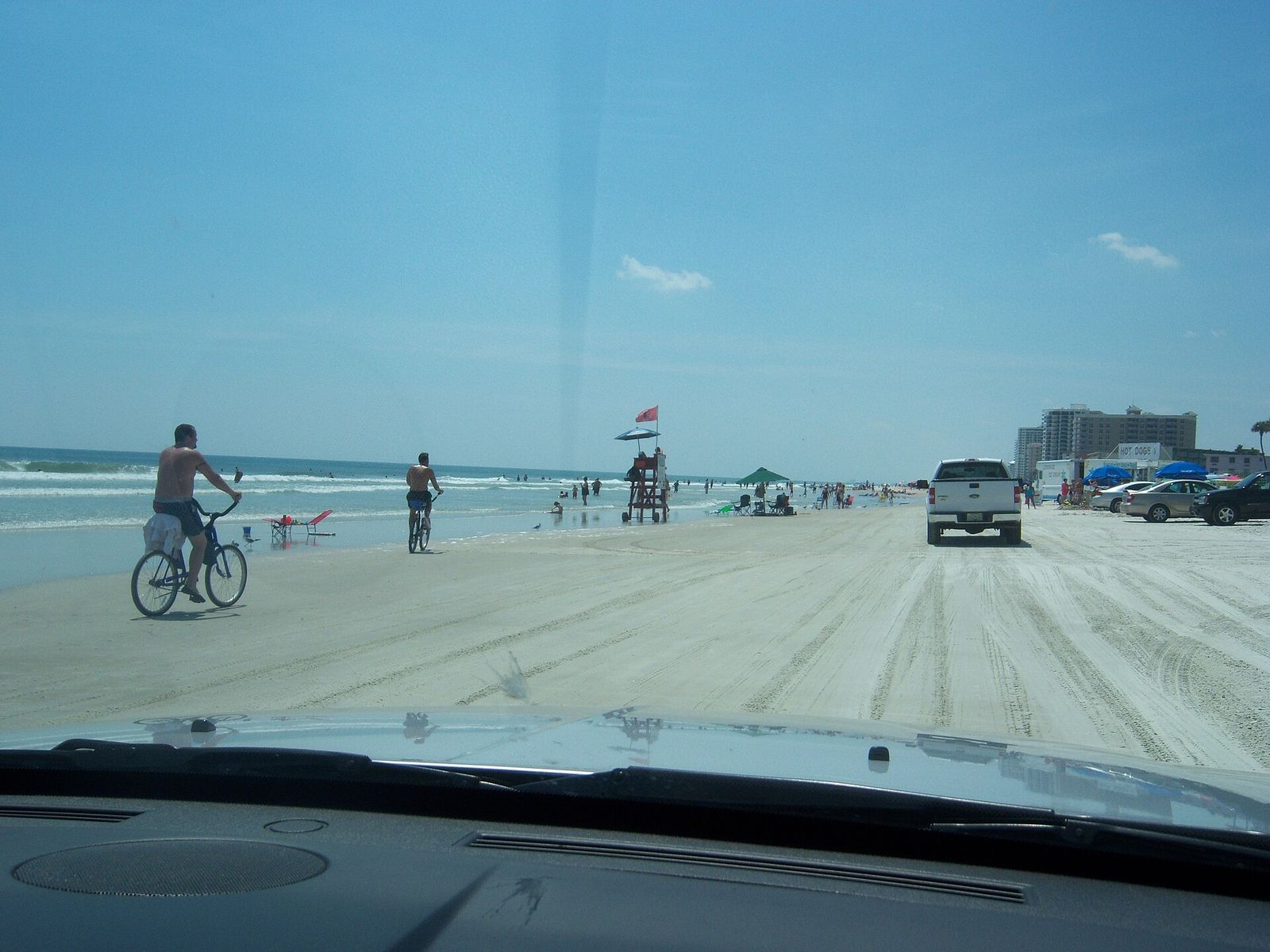 Cars parked and driving on the hard sand at Daytona Beach