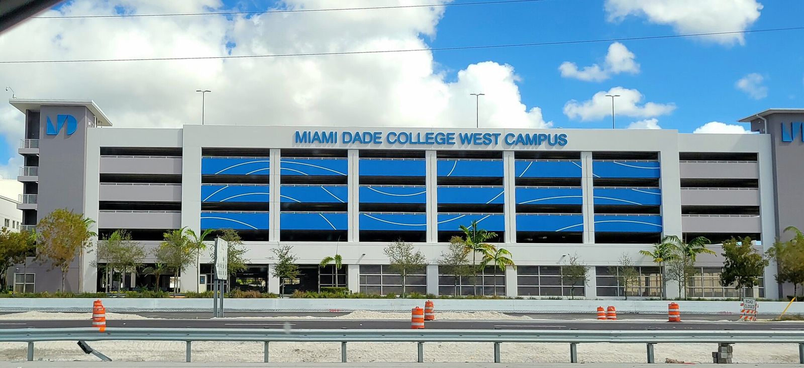 The Miami Dade College West Campus building with its blue panels, seen from Florida's Turnpike
