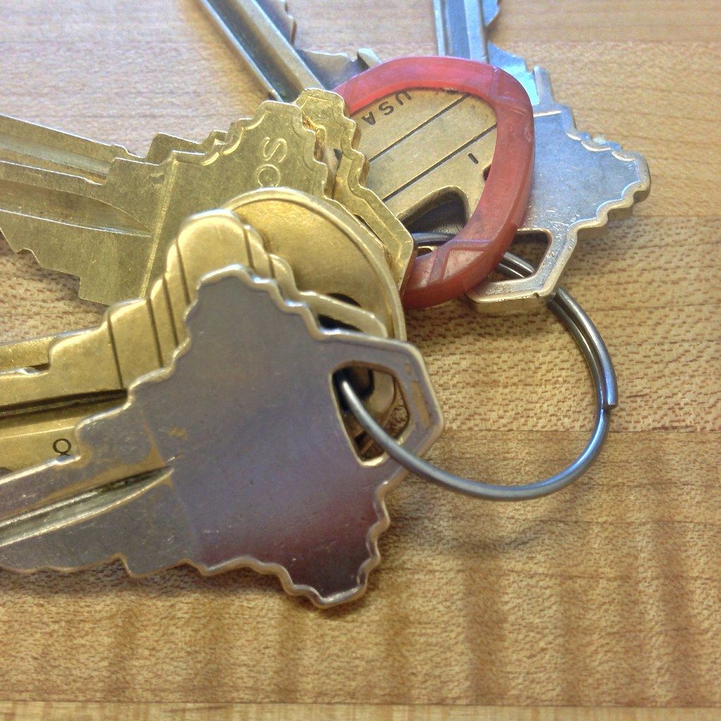 A set of new apartment keys on a wooden table