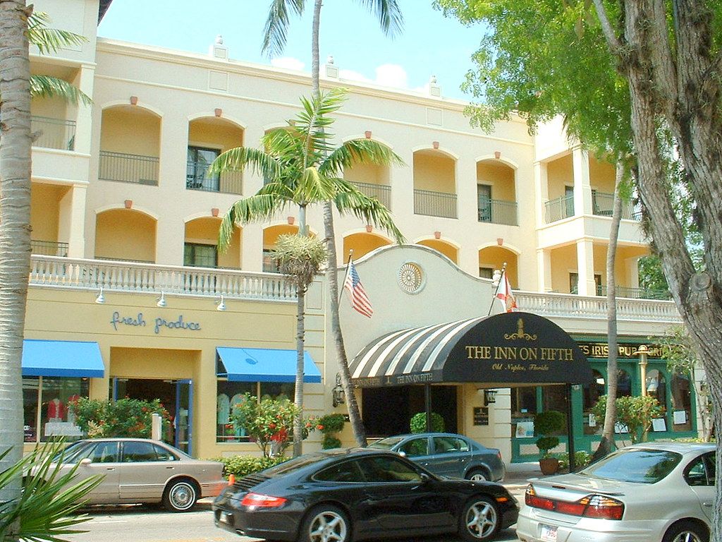 Shops and palm trees along Fifth Avenue South in Naples