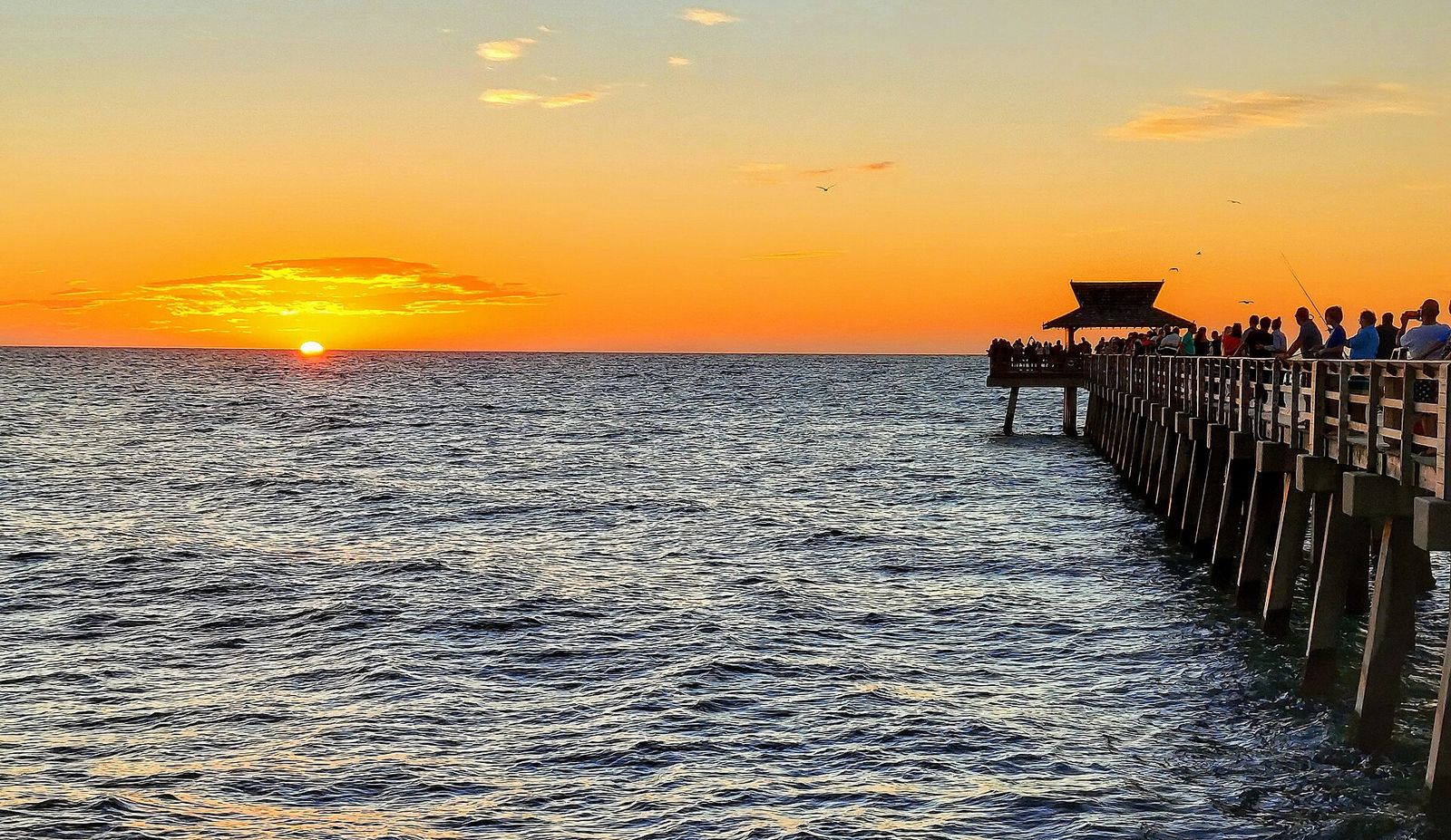 The Naples Pier silhouetted against a Gulf sunset