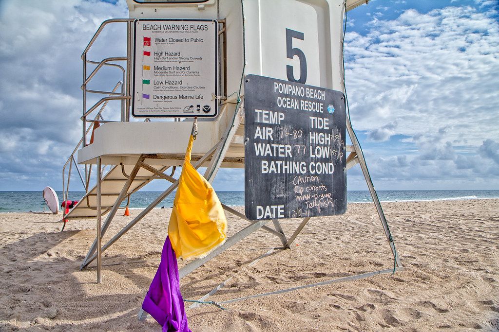 A lifeguard tower with a beach conditions board on Pompano Beach