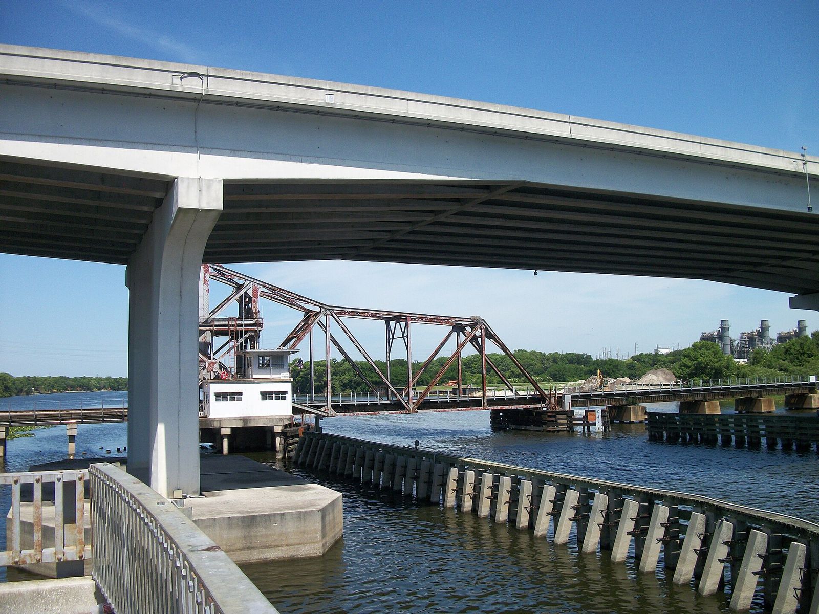 The old swing railroad bridge across the St. Johns River seen from beneath the high concrete Benedict Bridge at Lake Monroe in Sanford