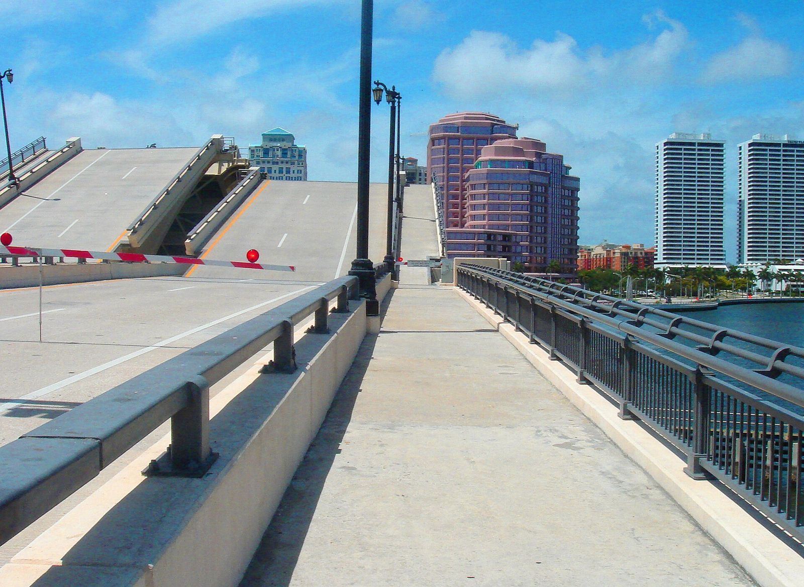 Walkway over a raised drawbridge with the West Palm Beach skyline behind