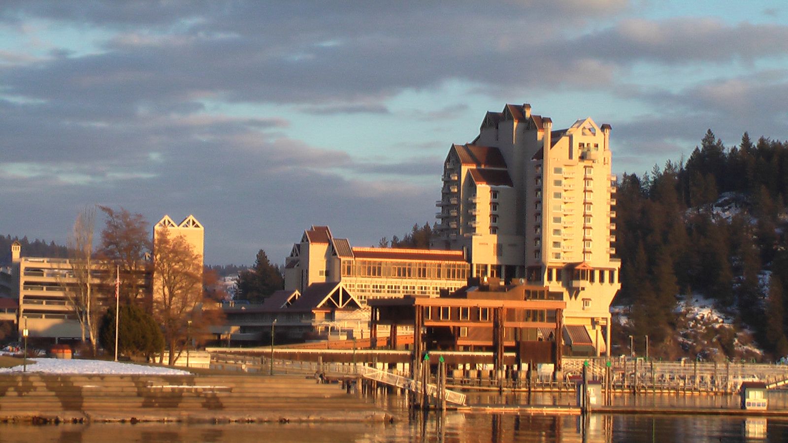 The Coeur d'Alene Resort tower and lakeside buildings in warm evening light on Lake Coeur d'Alene