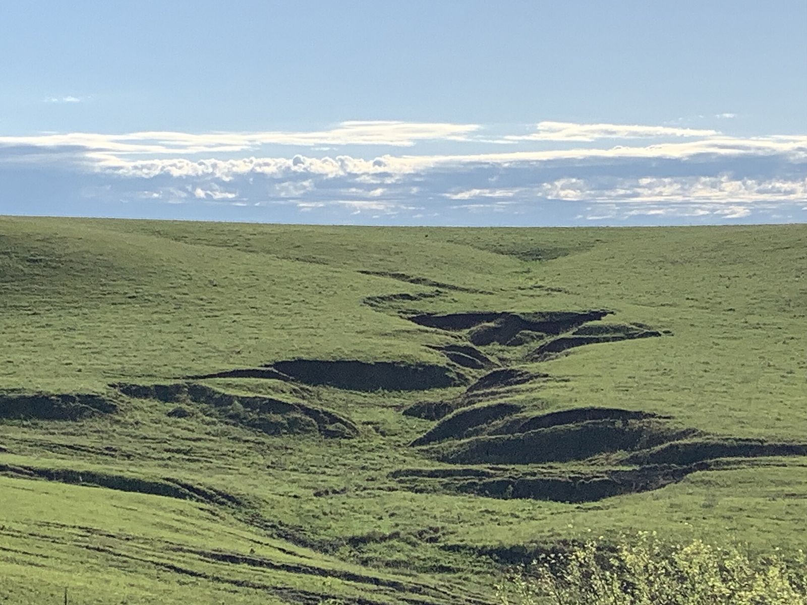 Rolling grassland of the Flint Hills in Kansas under a wide sky