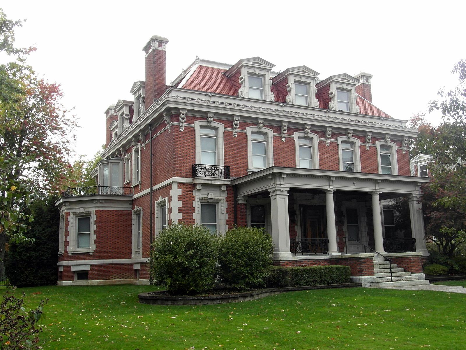 The John W. Bush House, a red brick home with a columned porch at 6 Lincoln Parkway in Buffalo, New York