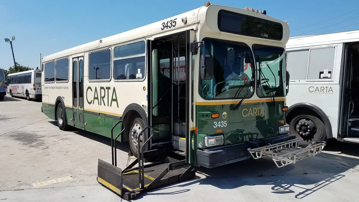 A CARTA bus at its Charleston garage with the wheelchair lift lowered and the front bike rack folded down