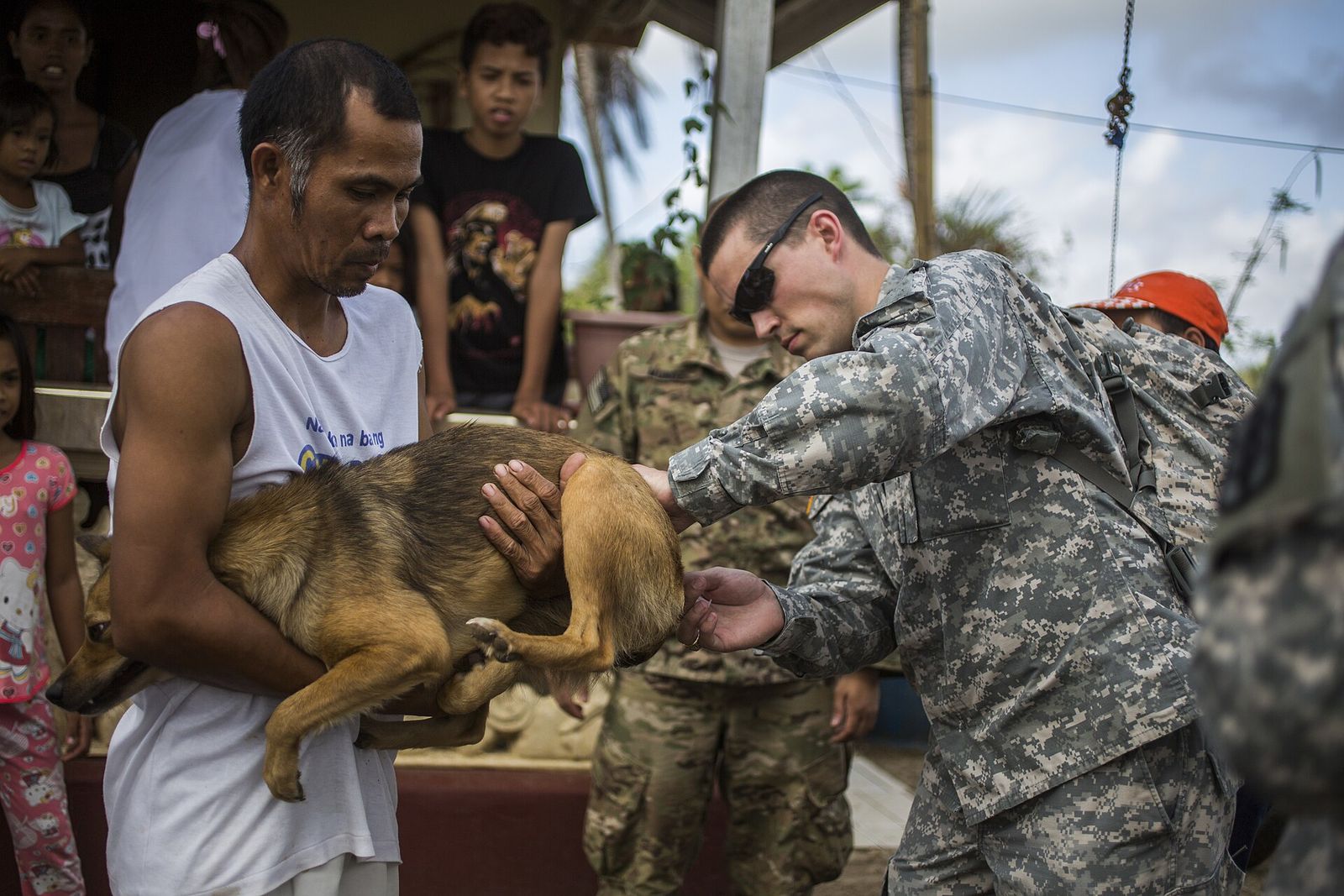 A veterinary team member holds a dog during a vaccination clinic