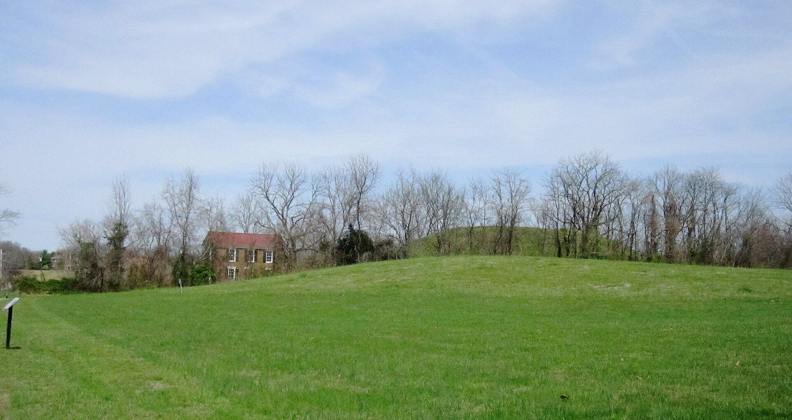 A grassy Mississippian earthwork mound at the Fewkes site in Brentwood