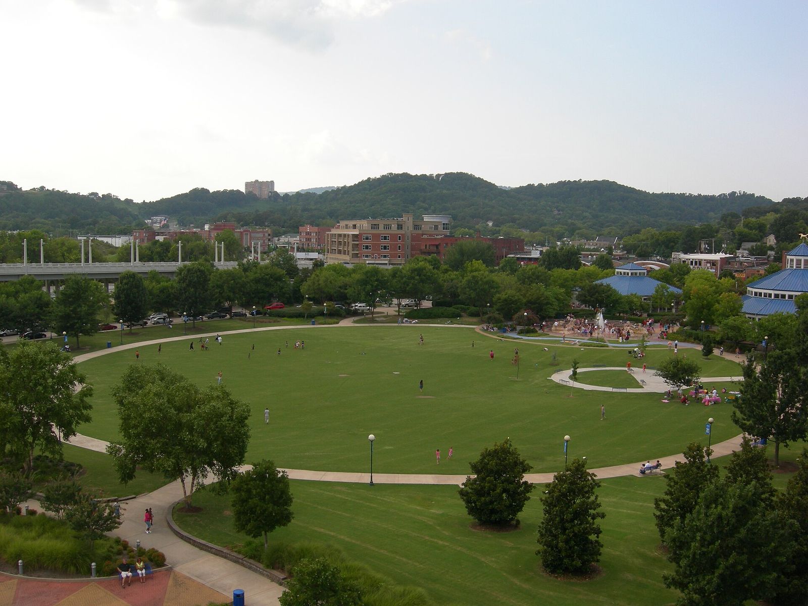 Lawns and walking paths at Coolidge Park with ridges behind