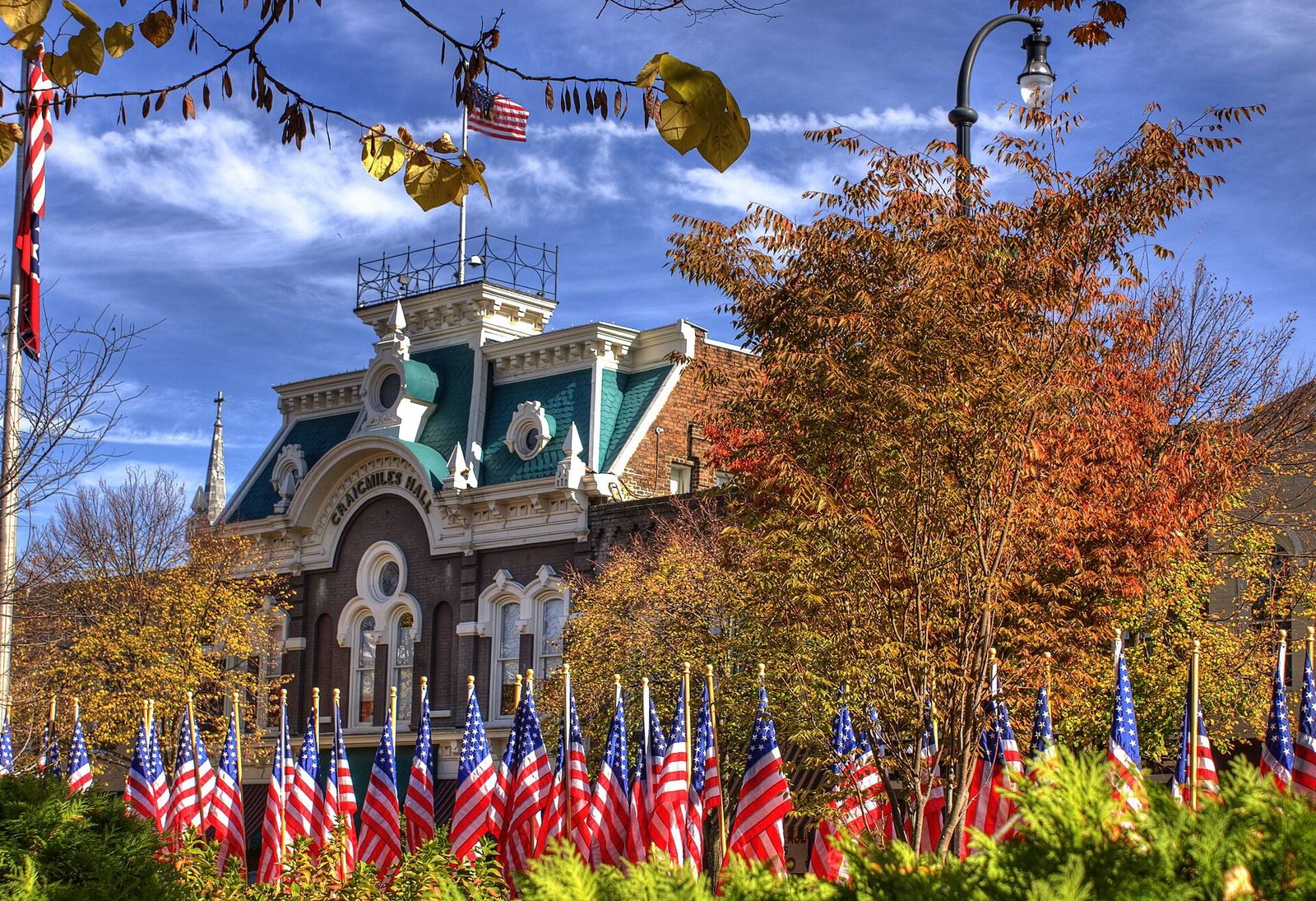 Craigmiles Hall with autumn trees and rows of small flags in downtown Cleveland