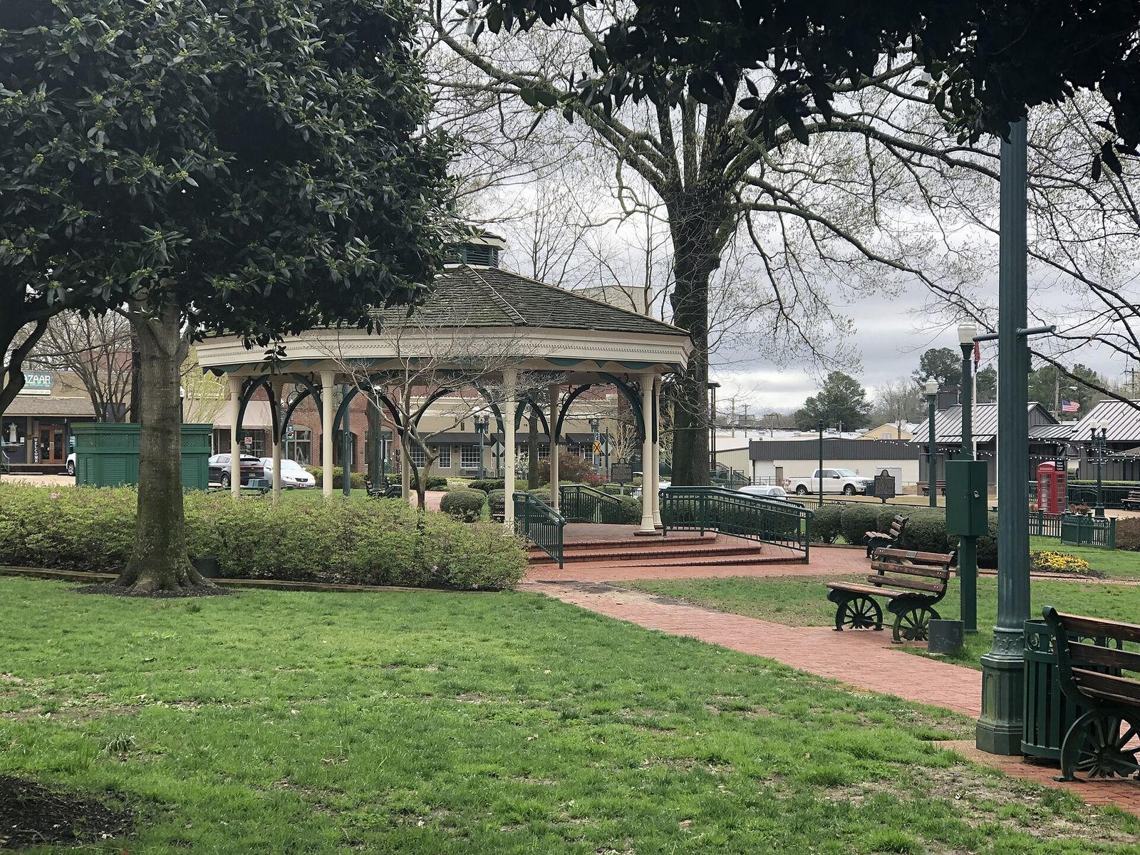 White gazebo and brick paths in the park at the center of the Collierville square