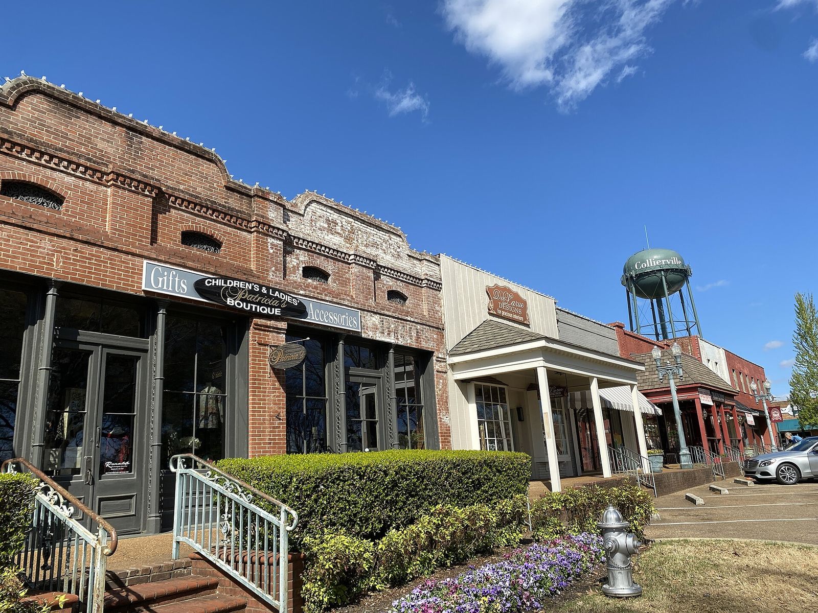 Brick shops with porches and the water tower on Collierville's town square