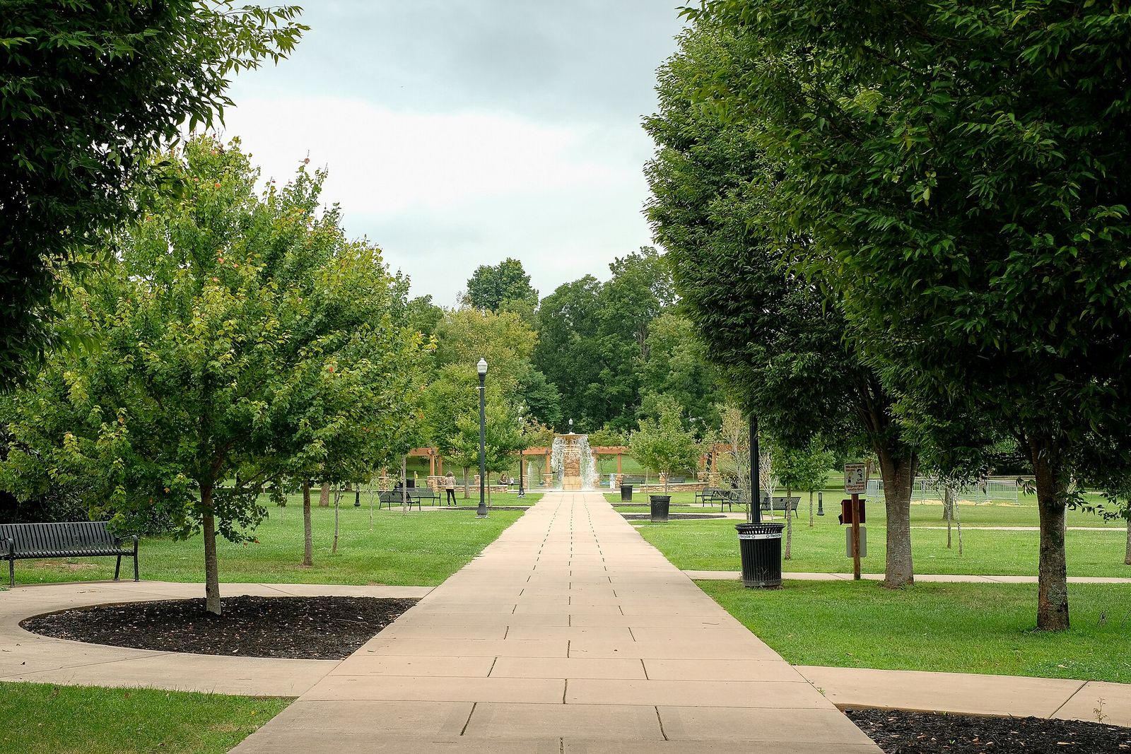 A tree-lined walkway into Dogwood Park from East Broad Street