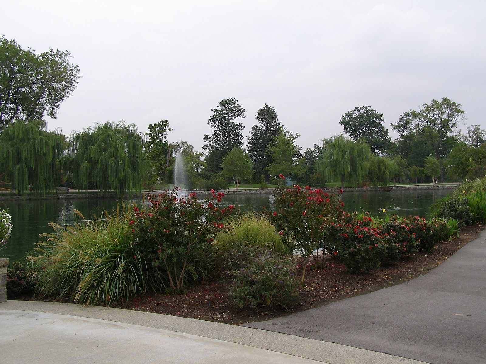 A lake with a fountain, willow trees and flower beds in Centennial Park, Nashville