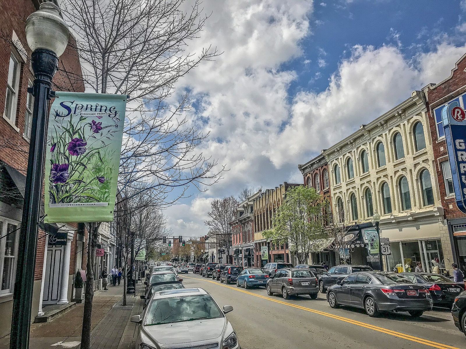 Brick and Italianate storefronts with parked cars along Main Street in downtown Franklin, Tennessee