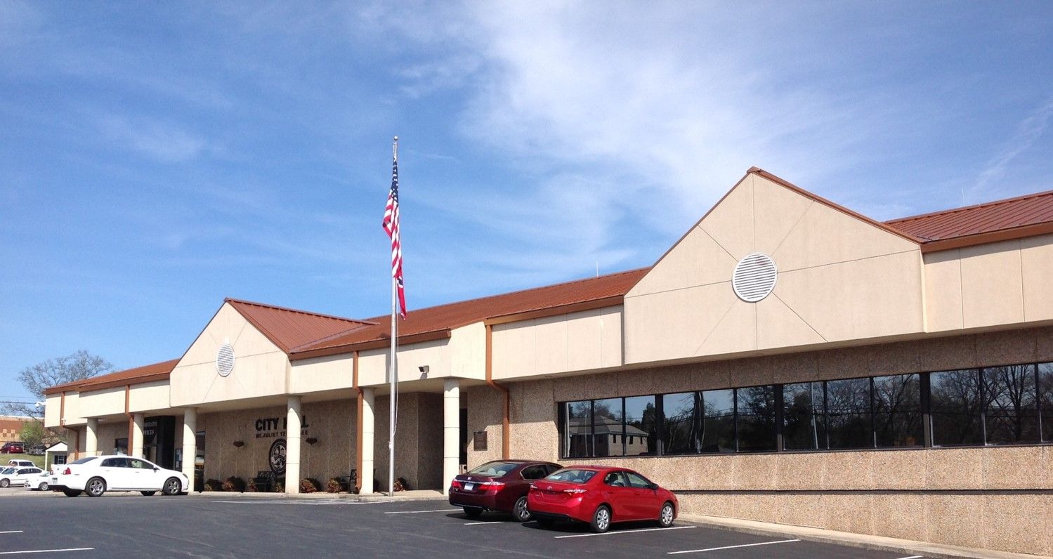 Mt. Juliet City Hall under a blue sky with a flag out front