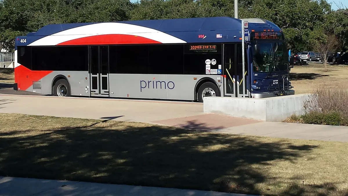 A VIA Primo bus waiting at the stop on the UTSA Main Campus in San Antonio
