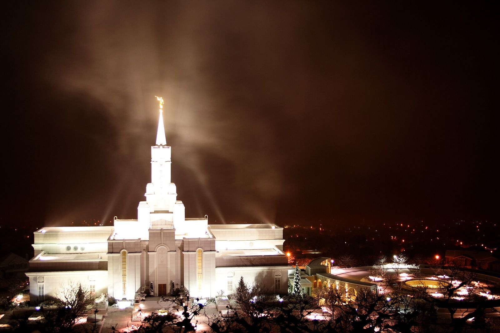 The Bountiful Utah Temple lit up at night above the city