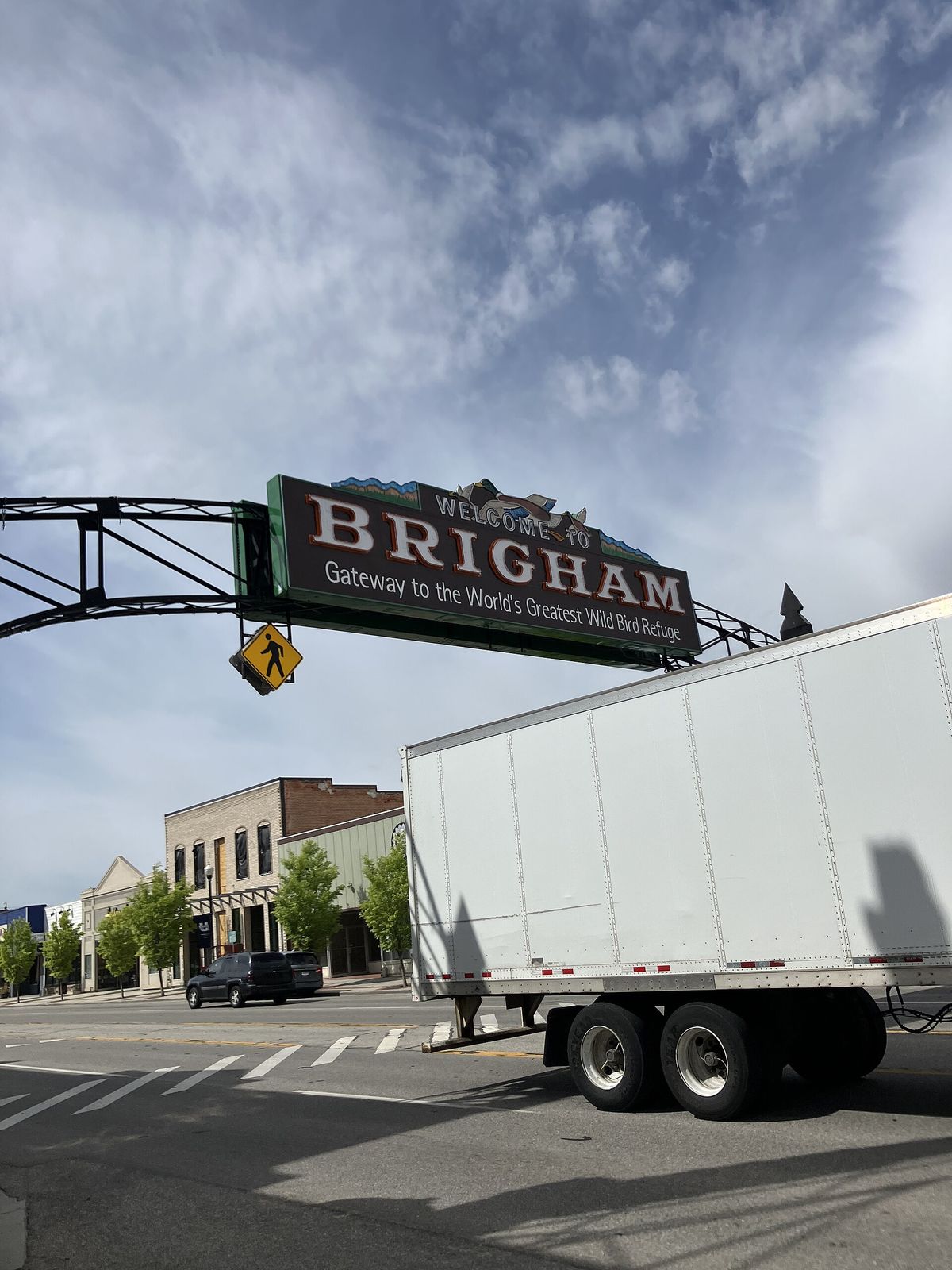 The arch spanning Brigham City's Main Street with its large BRIGHAM sign, above a truck and storefronts