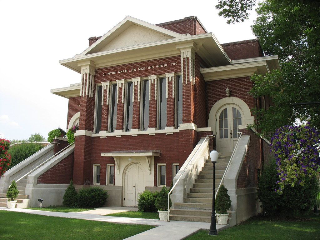 The red brick Clinton Ward meetinghouse of 1910, with white trim and twin stairways up to the entrance