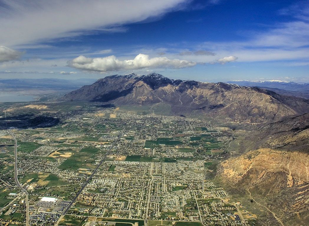 An aerial view of Ben Lomond rising above the neighborhoods and farmland north of Ogden