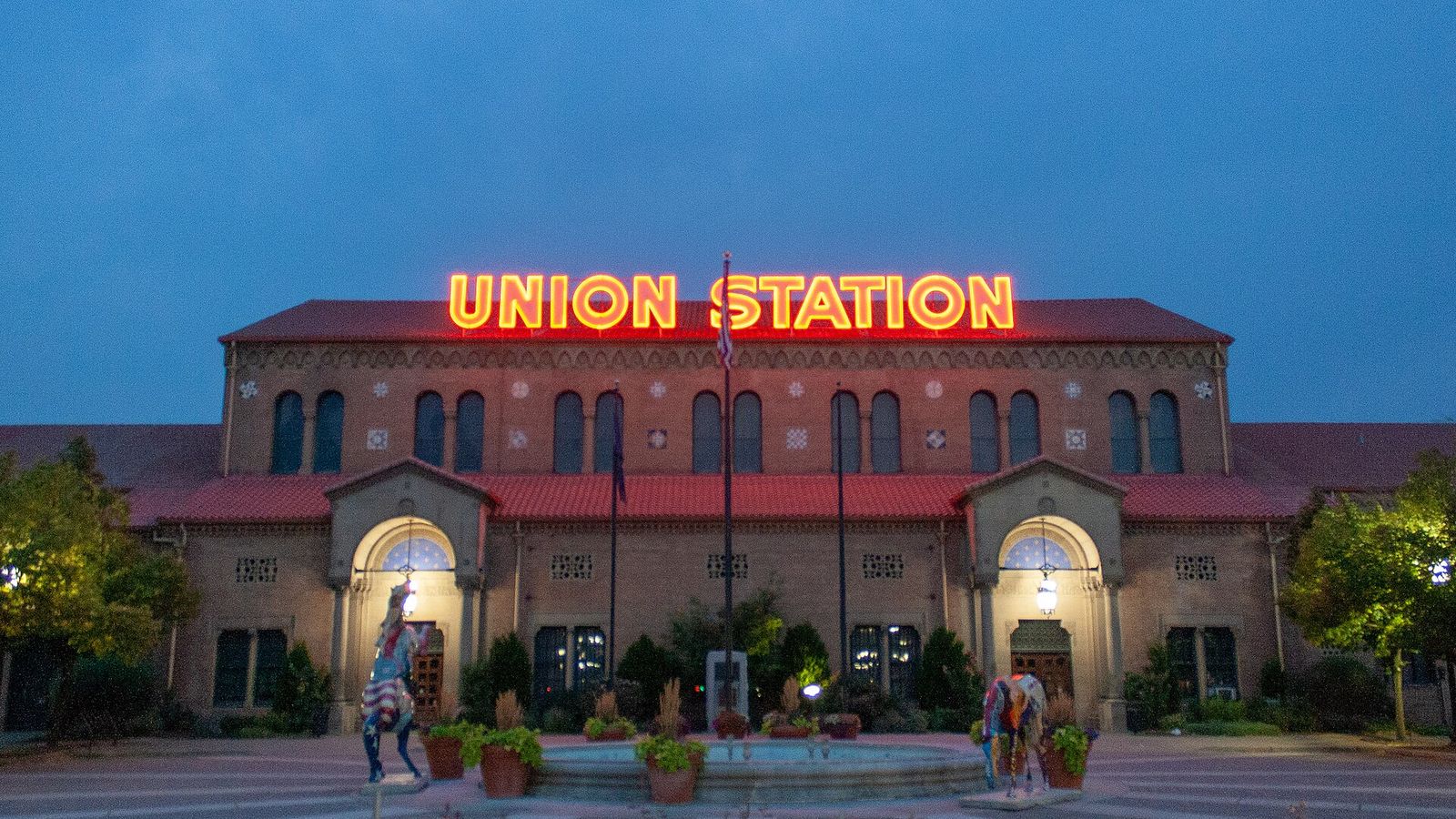 Ogden Union Station lit up at dusk, with its red Union Station sign above the entrance