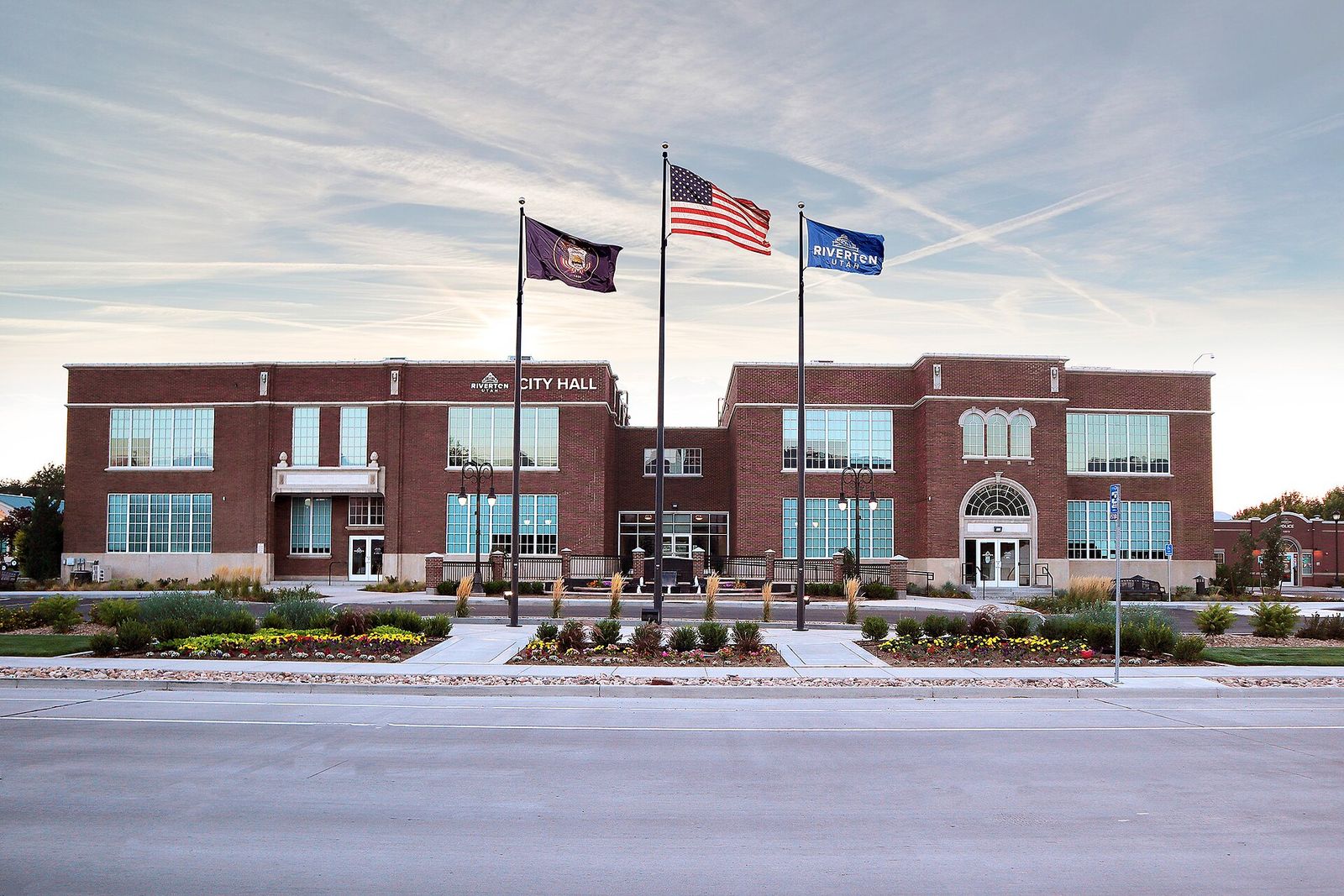 Riverton City Hall, a two-story brick building with three flags out front