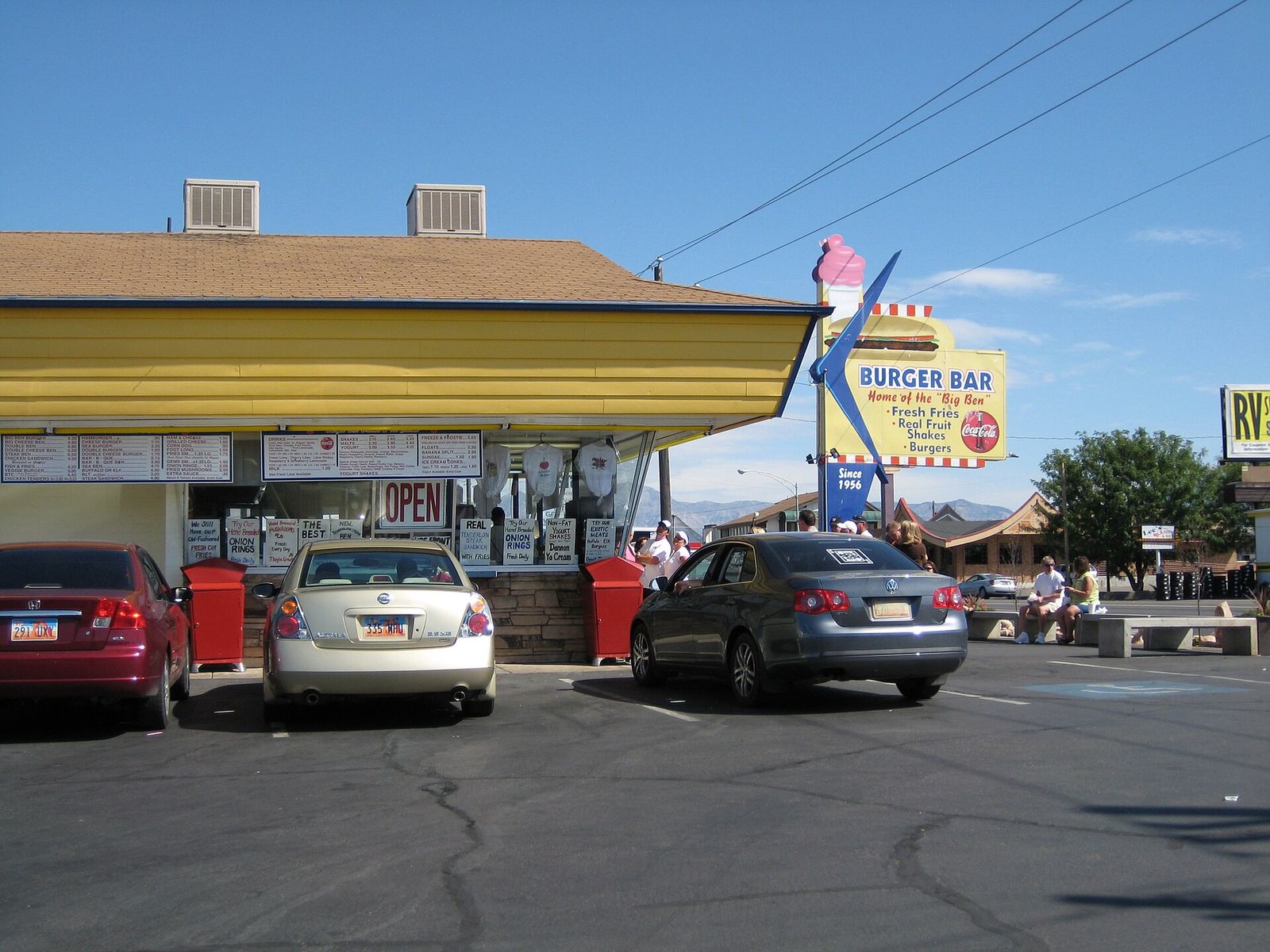 The Burger Bar drive-in in Roy with cars parked under its yellow awning