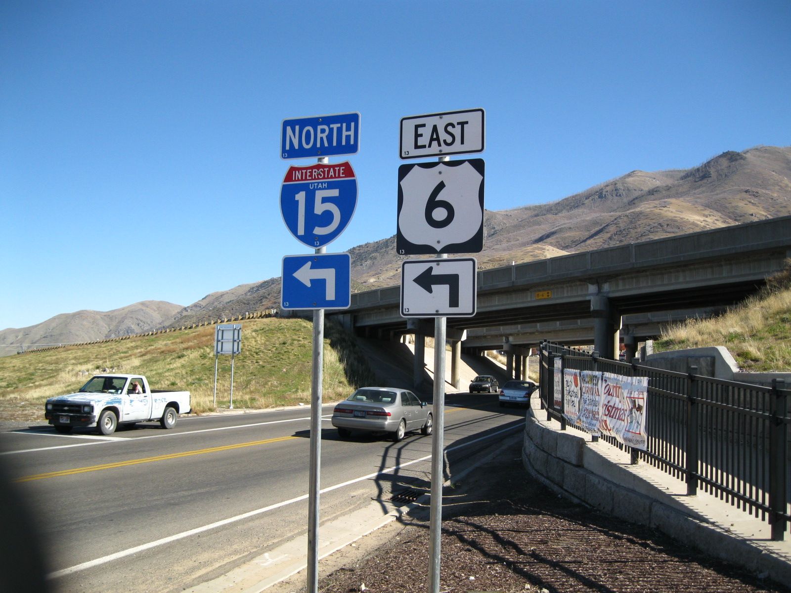 Interstate 15 north and US-6 east signs at the Santaquin interchange, with hills behind