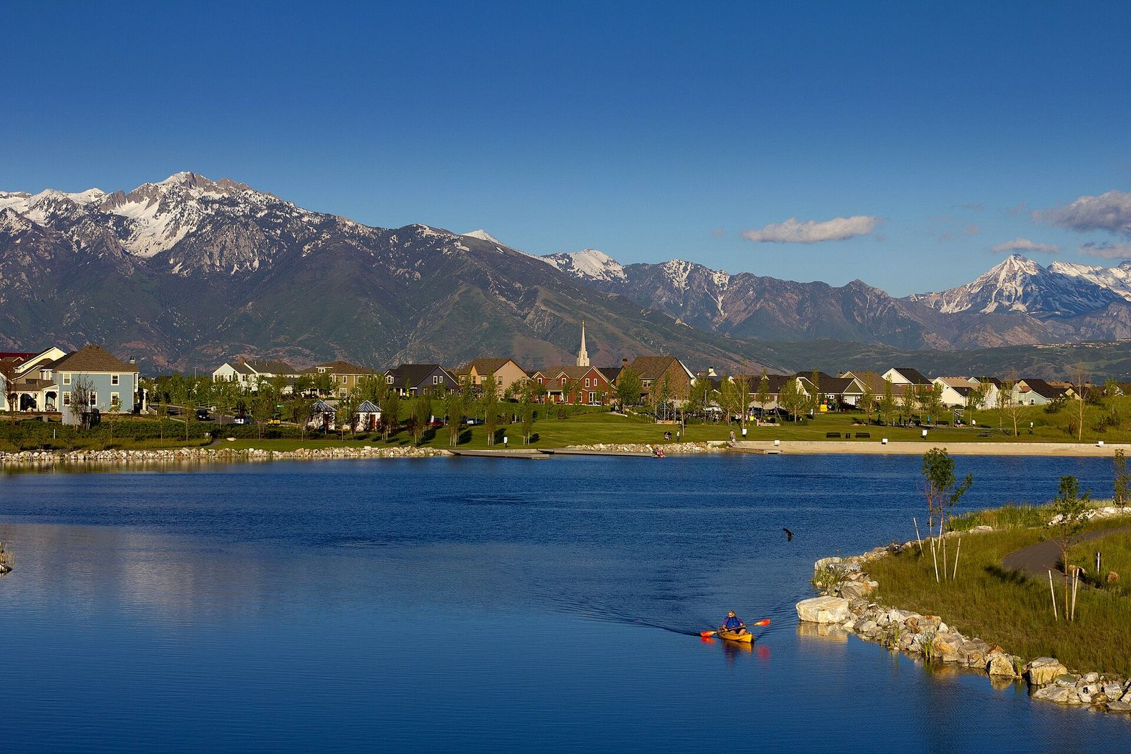 Homes of the Daybreak community around Oquirrh Lake, with the Wasatch Range behind