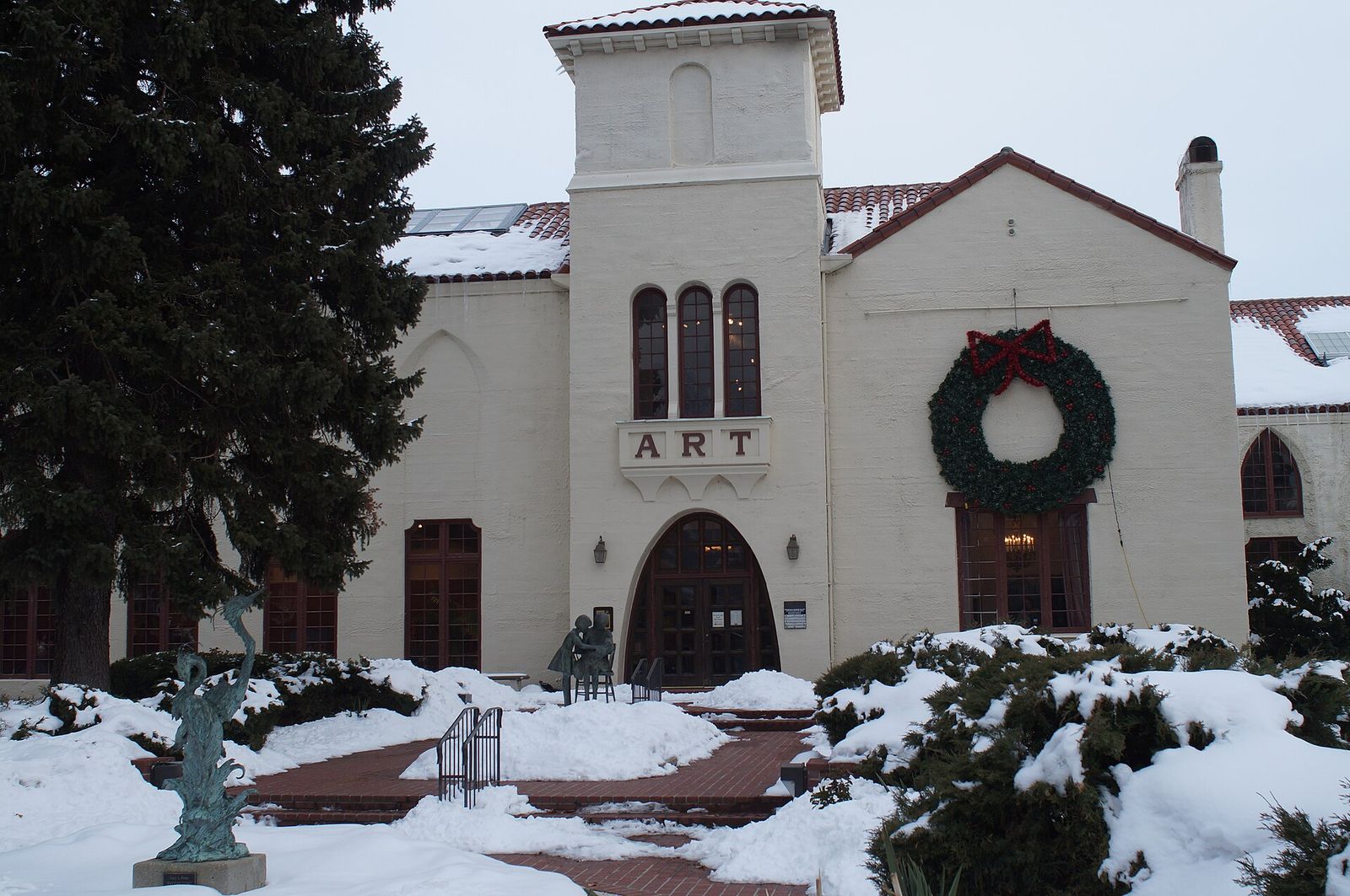 The Springville Museum of Art, a white building with an arched entrance and a wreath, after a snowfall