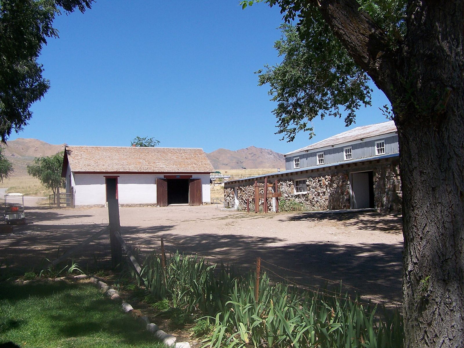Old ranch buildings at the Fielding Garr Ranch on Antelope Island with mountains behind