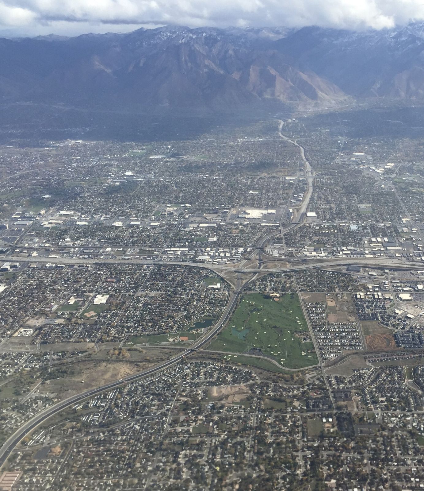 Interstate 215 crossing Taylorsville and neighboring cities, seen from an airplane looking east toward the Wasatch