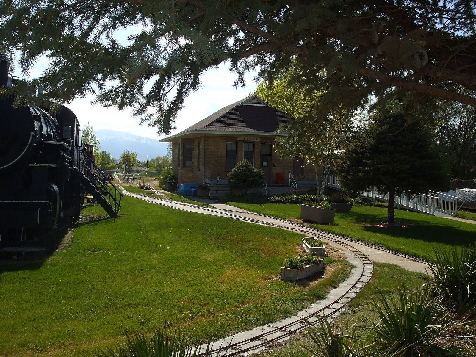 The Tooele Valley Railroad Complex, a depot museum with a steam locomotive and a loop of track on the lawn
