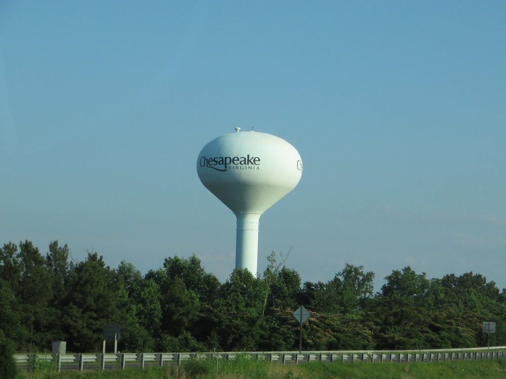 Chesapeake water tower rising above trees along a Chesapeake highway