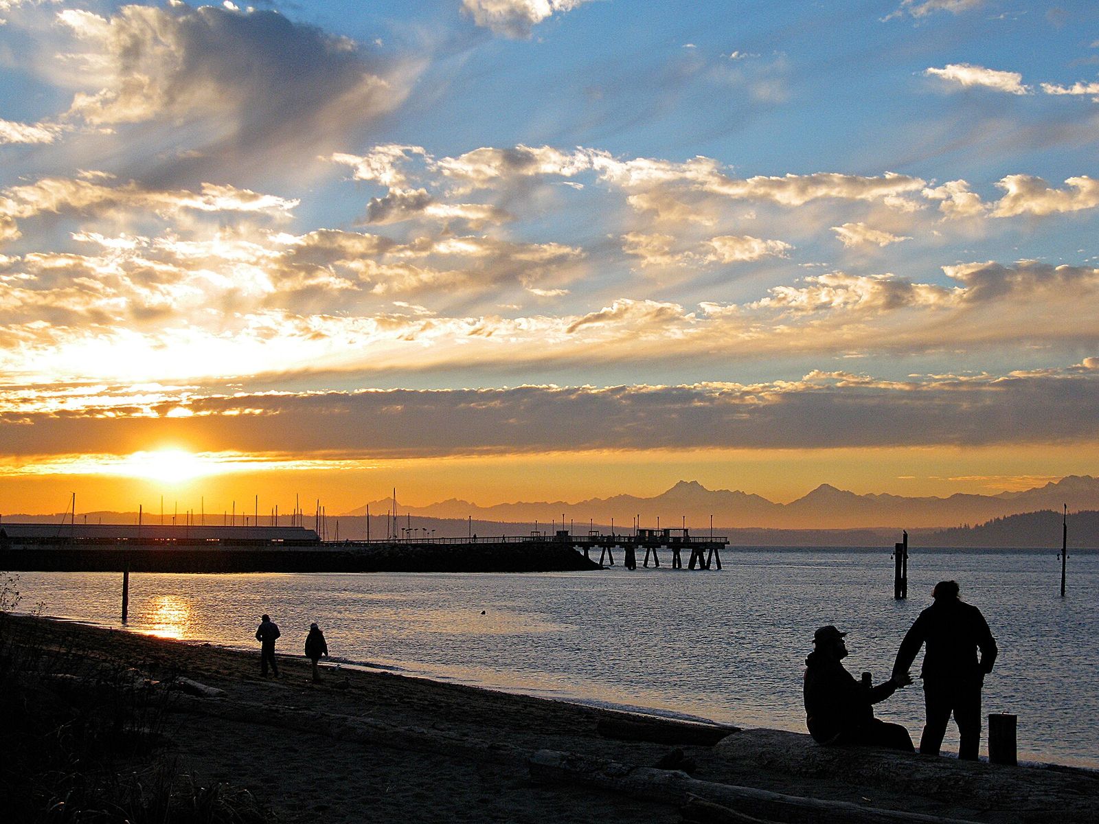 People watching the sun set over Puget Sound from the Edmonds waterfront