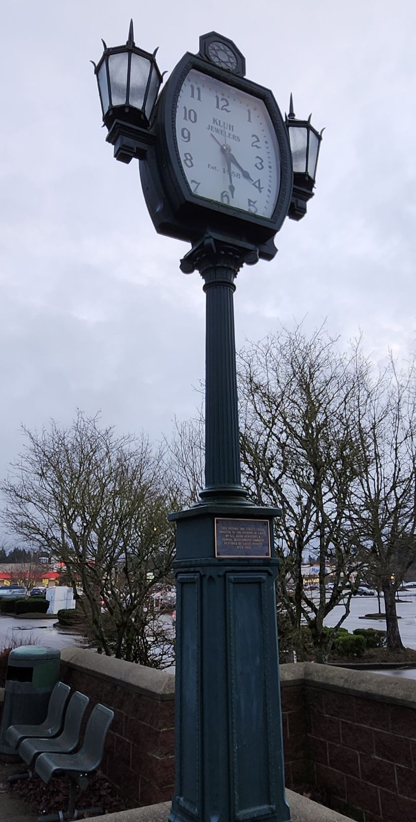 A tall black street clock in Lacey