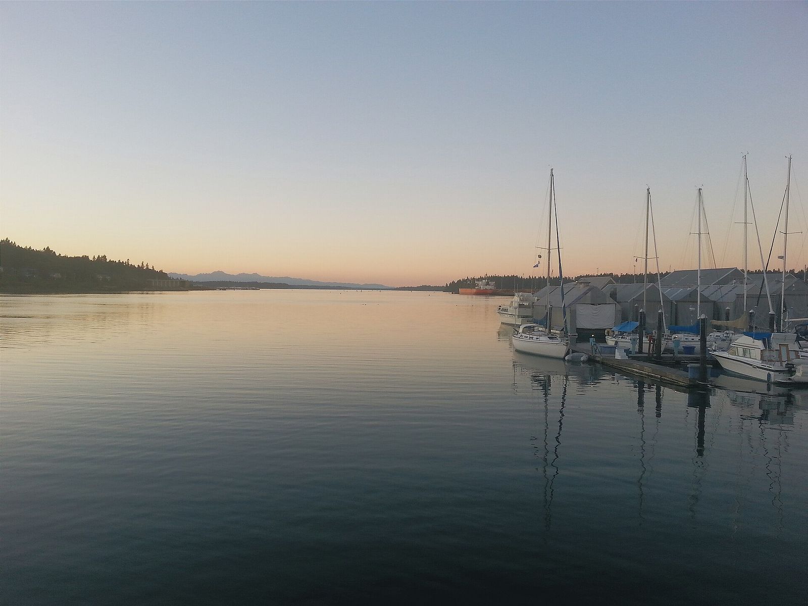 Boats and calm water at Percival Landing on Budd Inlet at dusk